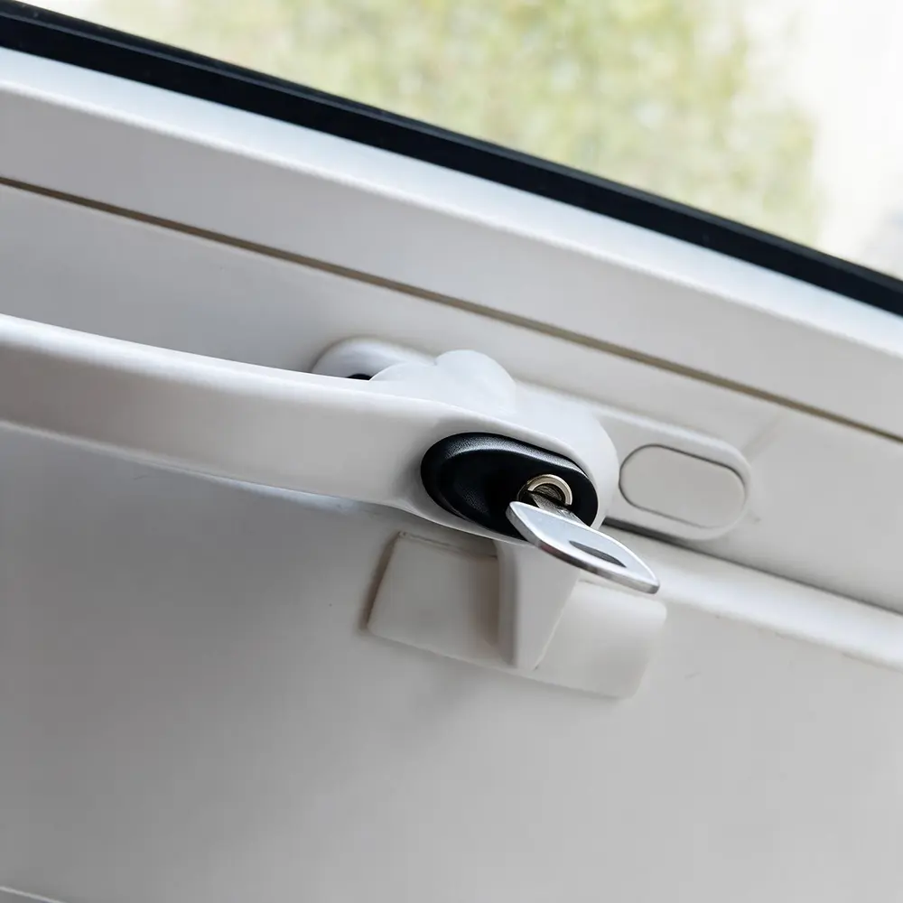 Locking button on a top hung uPVC window handle